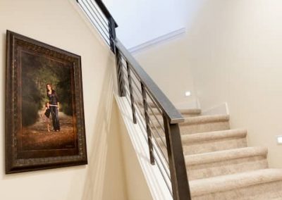 A staircase with a painting on the wall