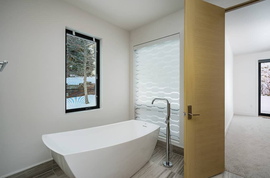 A bathroom with a tub and window in it