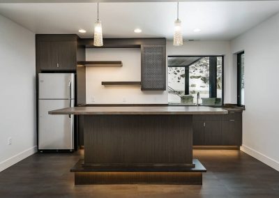 A kitchen with a refrigerator and counter in it