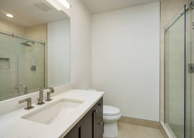 A bathroom with a sink, toilet and shower.