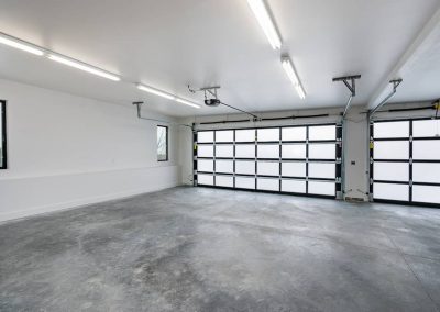A garage with two doors and no one in it.