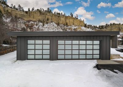 A garage door that is open in the snow.