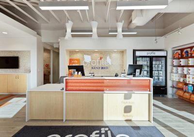 A reception desk with an orange and white counter.