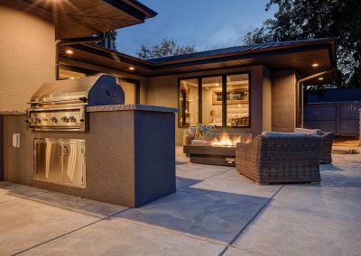 A patio with an outdoor grill and fire pit.