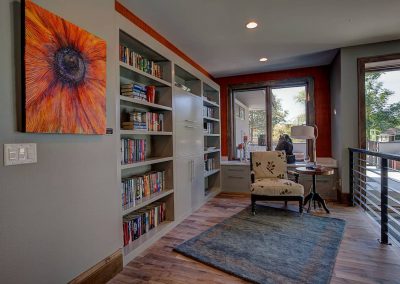 A room with a large window and a bookshelf.