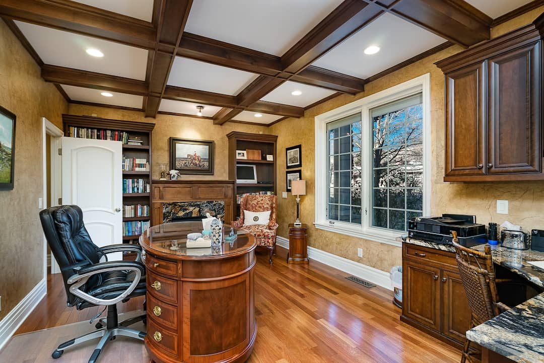 A room with wood floors and a desk.