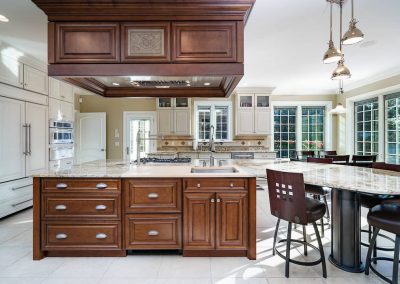 A kitchen with wooden cabinets and white counters.