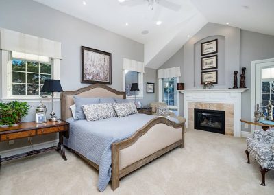 A bedroom with a fireplace and a bed in it