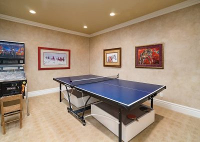 A ping pong table in the corner of a room.